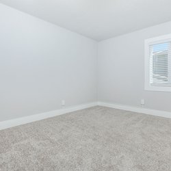 Carpeted primary bedroom at Stone Canyon Apartments, located in Colorado Springs, CO